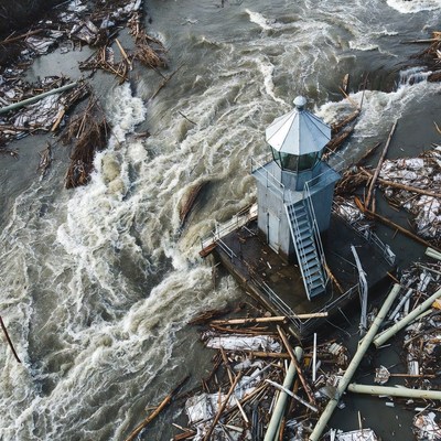 Lighthouse amid Flood Debris