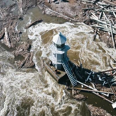 Lighthouse amid flood debris