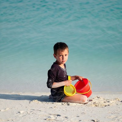 Boy with bucket and shovel on beach