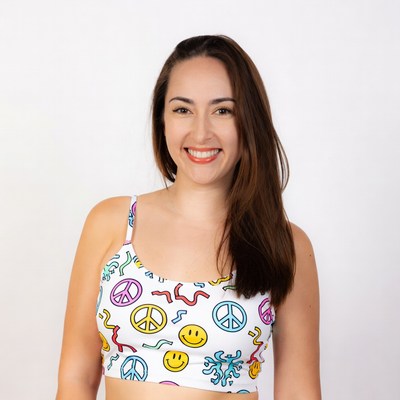 Woman smiling in colorful smiley top