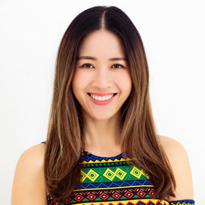 Asian woman smiling in colorful dress