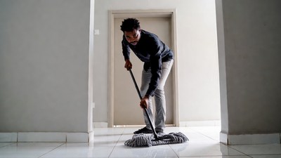 African-American man mopping floor