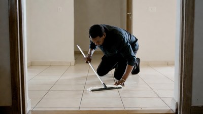 Man mopping floor in doorway