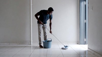 African-American man mopping floor