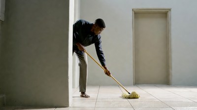 African-American man mopping floor