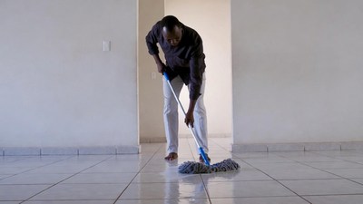 African-American man mopping floor