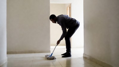 African-American man mopping floor