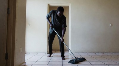 African-American man mopping floor