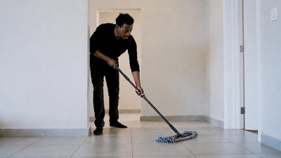 Man mopping floor in hallway