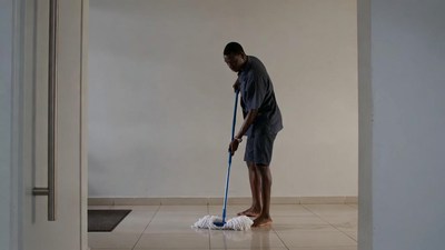 African-American man mopping floor