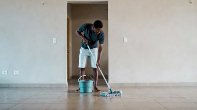 African-American man mopping floor