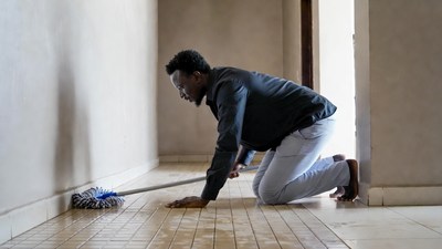 African man mopping floor