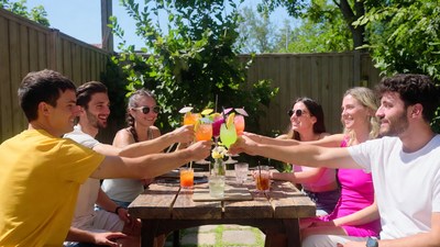 Group toasting with tropical cocktails outdoors