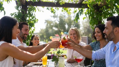 Diverse group toasting drinks outdoors