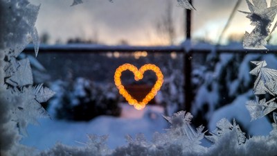 Glowing Heart Lights in Snowy Window