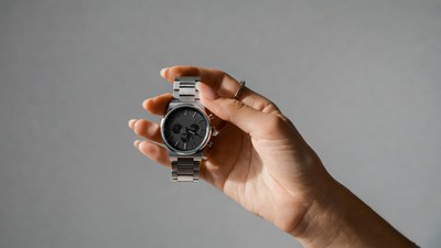Woman holding silver wristwatch