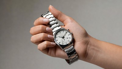 Woman's hand holding silver watch