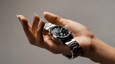 Woman holding silver wristwatch