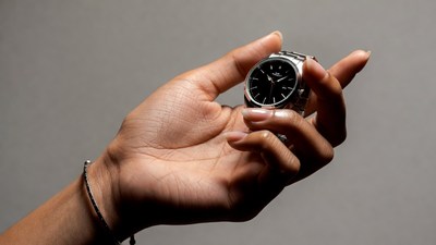 Hand holding black luxury watch