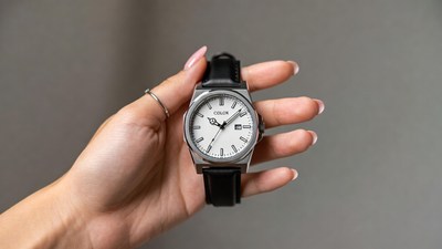 Woman holding white dial watch