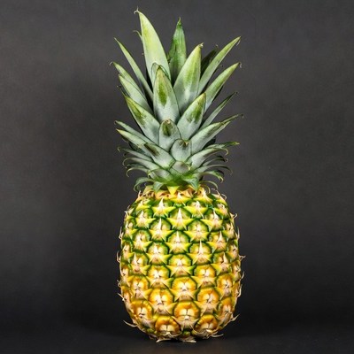 Fresh pineapple on black background
