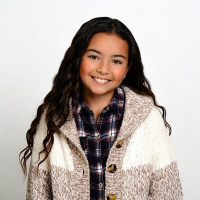 Smiling mixed-race girl in plaid shirt