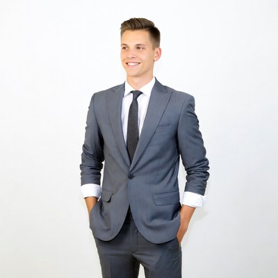 Young man in gray suit smiling