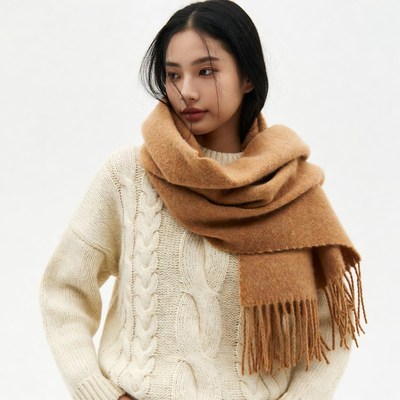 Asian woman in white sweater and brown scarf