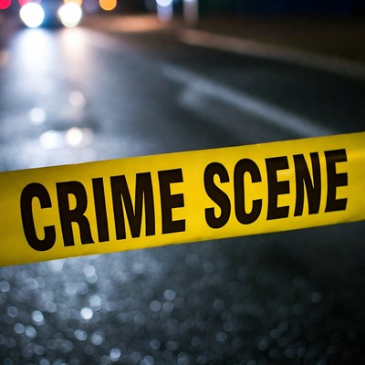 Crime Scene Tape on Wet Road at Night