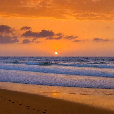 Sunset over beach with footprints