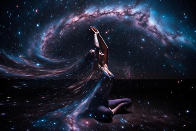 Woman meditating in cosmic galaxy