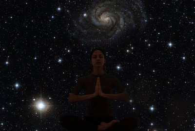 Woman meditating with galaxy background
