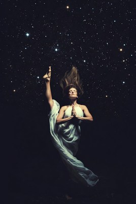 Woman in yoga pose among stars