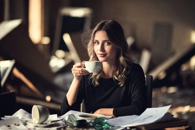 Woman drinking tea at desk