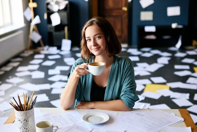 Woman drinking coffee at desk