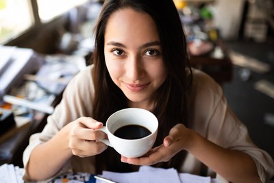 Asian woman holding coffee cup