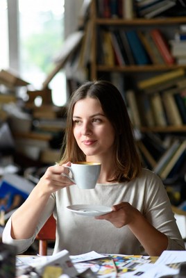 Woman drinking coffee in library