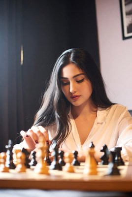 Woman playing chess game