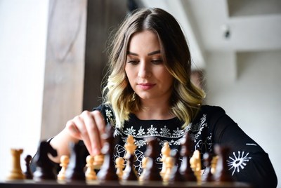 Woman playing chess game