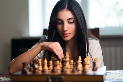 Woman playing chess game