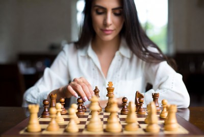 Woman playing chess game