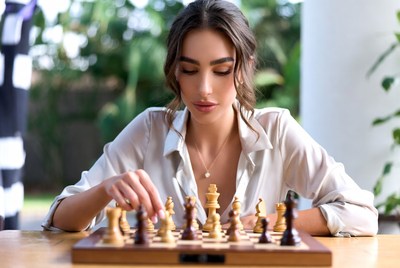 Woman playing chess outdoors