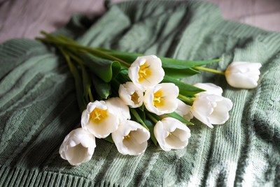 White tulips on green sweater