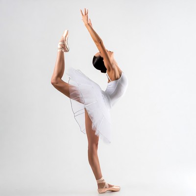 Ballerina performing white tutu arabesque