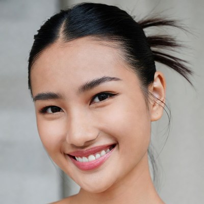Smiling Asian woman with ponytail