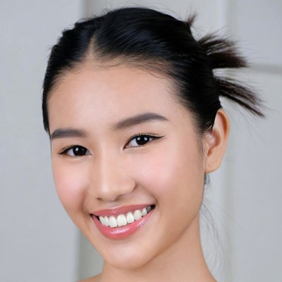 Smiling Asian woman with bun hairstyle