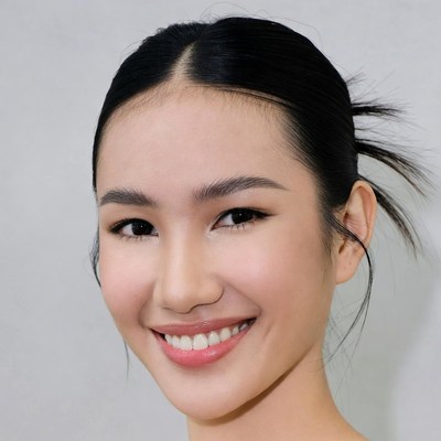 Asian woman smiling with bun hairstyle