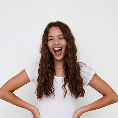Teen girl laughing with hands on hips