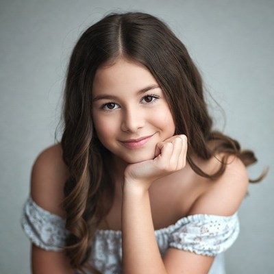 Smiling girl with hand on cheek