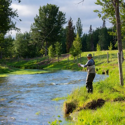 Man fly fishing by river
